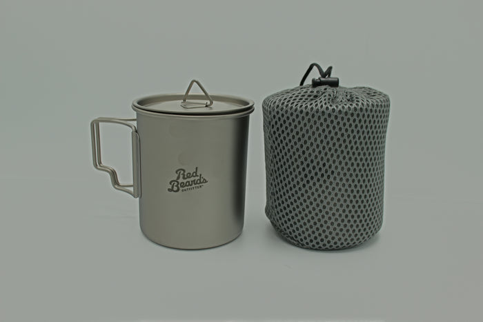 Red Beard’s Outfitter titanium camping mug with lid and mesh storage bag